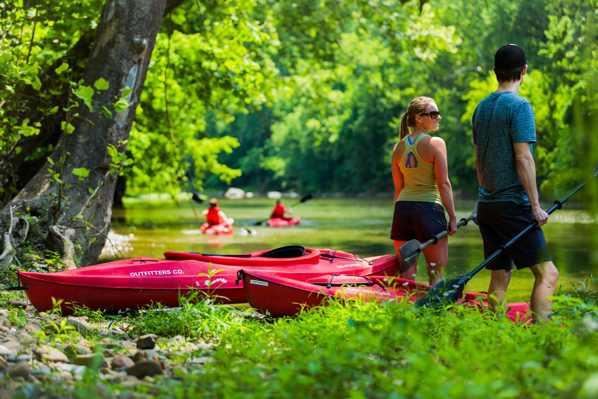 Couple standing at the shore kayaking