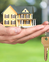 model house and key being turned over to new owner